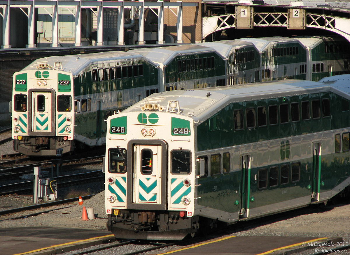 It's 5:18pm, and the rush hour dance of trains in and out of Union Station is in full swing. GO cab car 248 on Barrie line train #805 and 237 on Lakeshore West #483 depart the train shed, with commuters leaving Toronto crammed into both levels of each car.