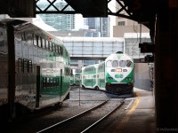 GO Transit MP40PH-3C 625 ducks under the train shed hauling the equipment for Georgetown-bound train 209, at the height of rush hour in Toronto. Even though their train and platform have not been officially announced yet on GO's electronic displays, 209's regular commuters crowd the platform behind the photographer waiting to get an earlybird seat.