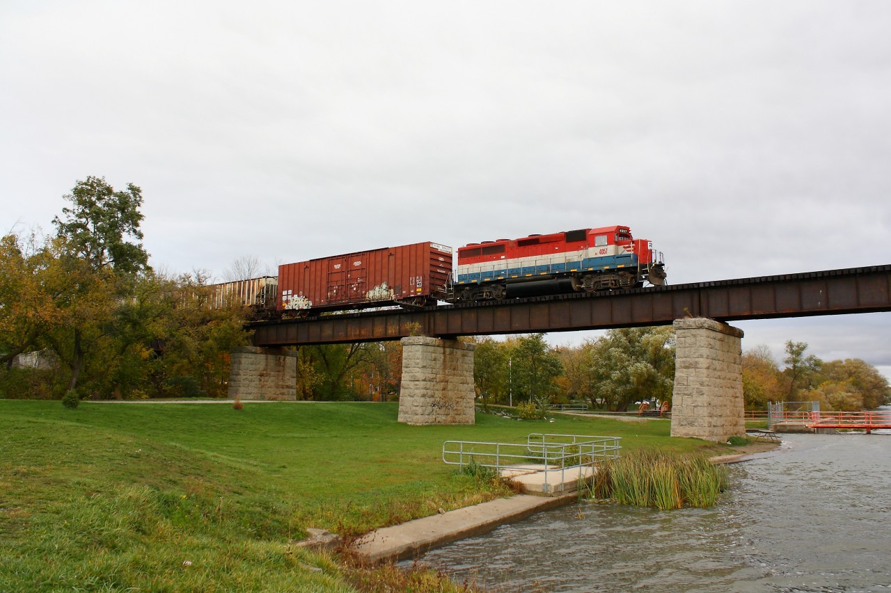 RLK 4057 crosses the Grand River at Caledonia Ontario under threatening skies with six cars for Garnet Ontario.  This daily train is usually through town around five.  Today they were running through at 4:47pm.