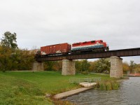 RLK 4057 crosses the Grand River at Caledonia Ontario under threatening skies with six cars for Garnet Ontario.  This daily train is usually through town around five.  Today they were running through at 4:47pm.