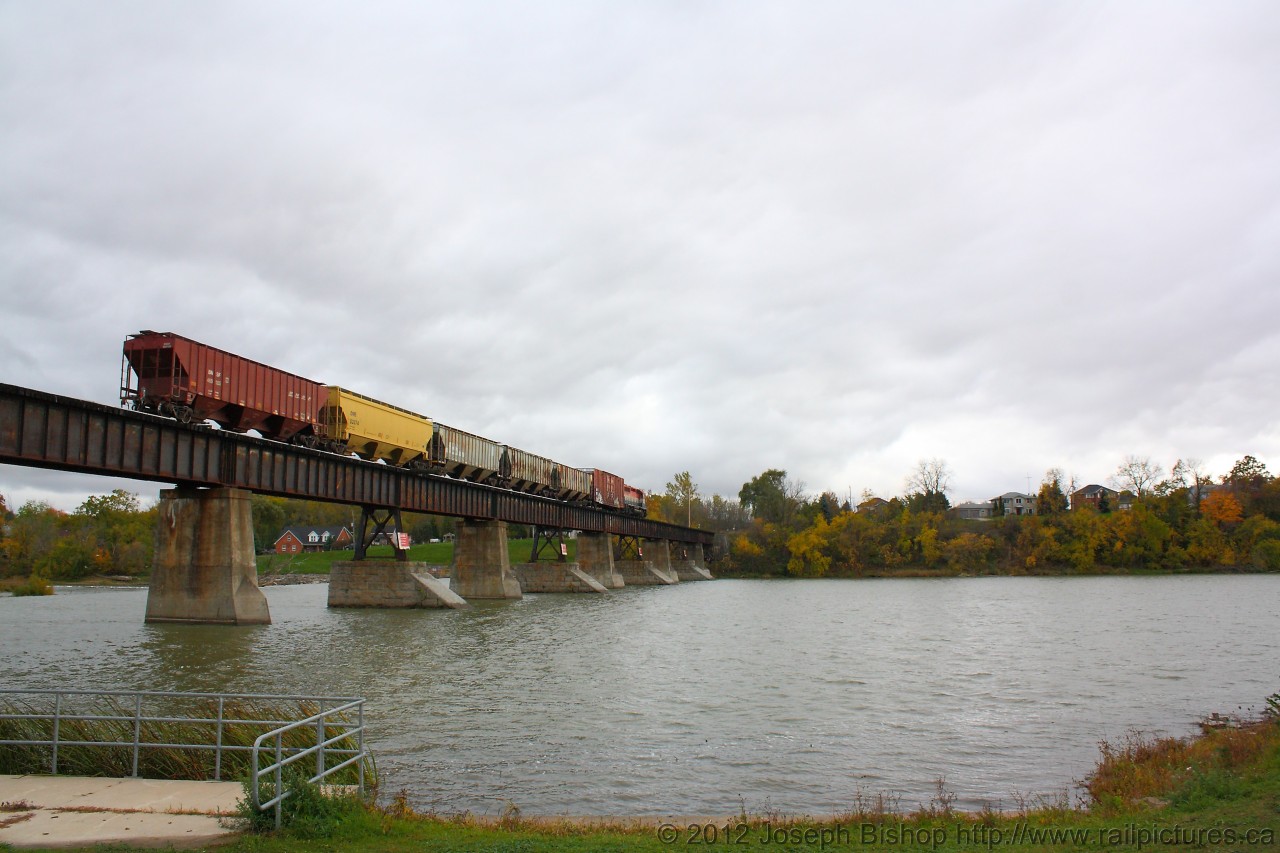 As RLK 4057 nears the end of the bridge at Caledonia, the locomotive and cars bring more fall colours than the trees in the right hand side of the photo.