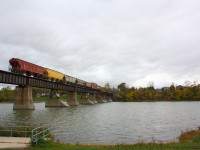 As RLK 4057 nears the end of the bridge at Caledonia, the locomotive and cars bring more fall colours than the trees in the right hand side of the photo.