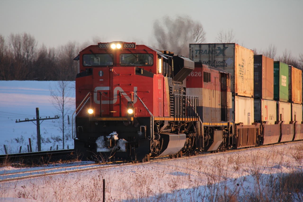 A northbound container train, likely #107, starts to pull after meeting a southbound manifest at the North end of Brechin.