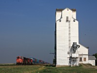 CN eastbound intermodal with three GE's roars by Rivers Manitoba's elevator.