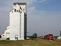 CP P34 with 3030 leading two other GP38-2's passes the towering former Manitoba Wheat Board elevator now privately owned at Reston Manitoba once a stop on the Arcola Subdivision but that is a thing of the past as the elevator tracks as evidence have been tore up.