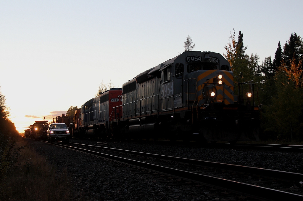 CN 480 passes through Wagaming at dusk. The NOD Surfacing gang is in the ditch, which will follow the train to Auden.