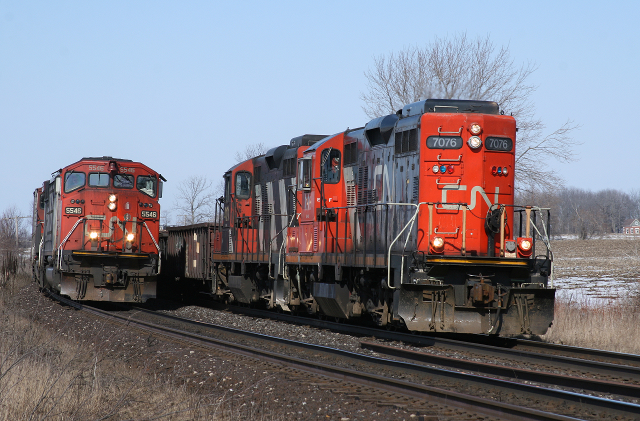 CN 399 (CN 5546) and SOR 598 (CN 7076) pace each other, as they round the curve at Power Line Road just outside of Brantford.