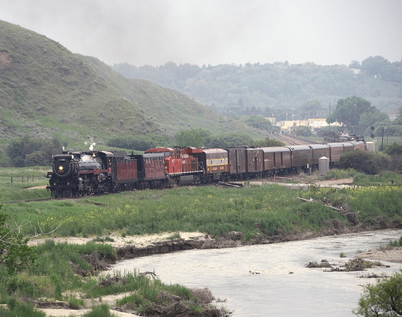 H1b 4-6-4 2816 with a westbound executive special bound for Regina departs from Medicine Hat along Ross Creek