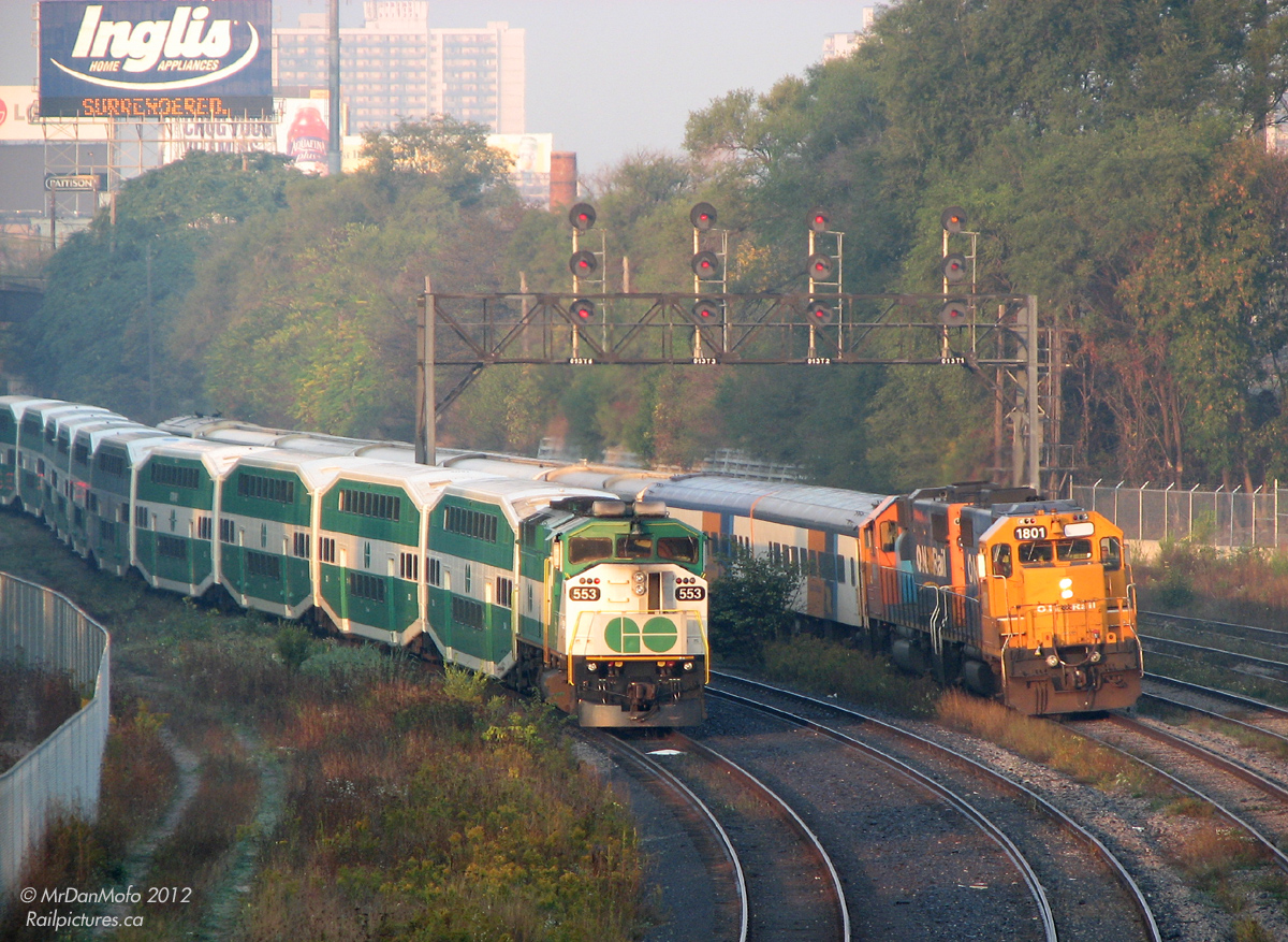 With an unusually large daily Toronto to Cochrane "Northlander" with 2 ex-CN cars, 5 ex-GO single levels and an APU tacked on the rear, ONT GP38-2's 1801 and 1806 pull equipment move #697 from Mimico to Union Station,  passing GO 553 off Milton Line run #152 at Bathurst St (8:03am).  Upon discontinuation by the Ontario Liberal government at the end of September 2012, this train and the vital link it serves as a connection between small communities along the line in Northern Ontario is now history.