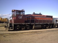 QIT 69 gets ready to leave for the mine with a tractor trailer loaded on a flat car.  Behind the locomotive sits QIT's recently purchased American 850-80 locomotive crane.
