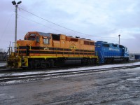 QG 2007 and friend GATX 2646 sit coupled with their backs to each other as they wait for their next assignment at Quebec Gatineau's marshalling yard in Sainte-Therese, Quebec.