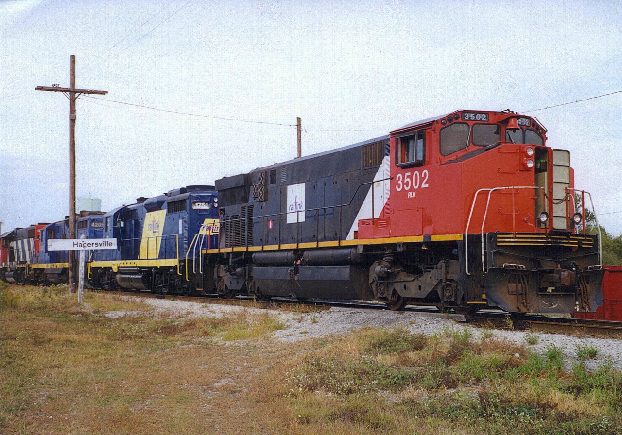 Back in the day...RaiLink (now Rail America) had ex CN M420's.  Here we see RLK 3205 leading three other RaiLink units through Hagersville Ontario.  Picture added with permission of the photographer.