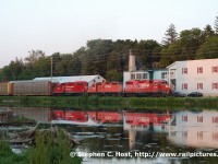 The Grand River Railway Galt evening job is cruising along the Speed River at Preston, curving onto what was once the GRR's Hespeler branch. GP38-2 3038, GP9 1516 and GP38-2 3097 have the honours of hauling today's second round of empty autoracks to the yard at Hagey for Toyota -- and bringing back a second set of loads back to Galt in the wee evening hours.