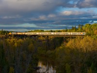 In its last days, the northbound Northlander crosses the large bridge just east of the yard in Englehart. 