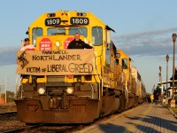 Ontario Northland employees display a politically charged banner on the porch of the lead locomotive on the final Southbound Northlander passenger train.
