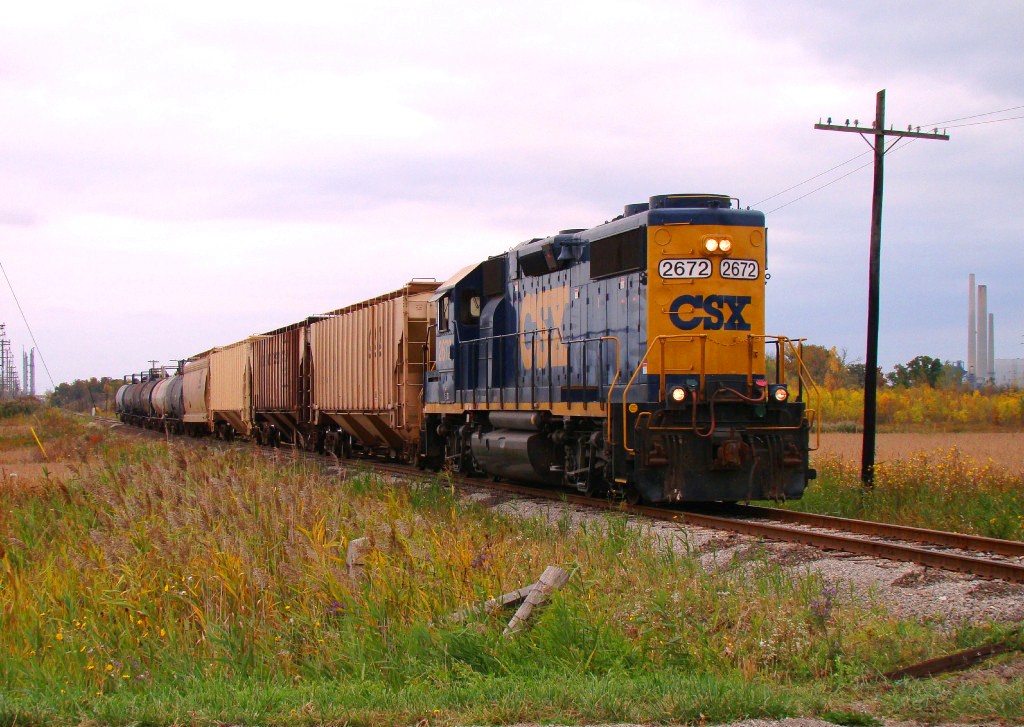 On a mostly overcast day, CSX D924 lead by Canadian assigned GP38-2 2672, heads back to Sarnia with 10 cars he picked up along the line.