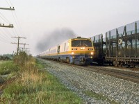 VIA 27 decelerates to 75 mph down the grade before  the curve with 2 extra coaches on this Saturday evening,CN 307 stands still for the 2 VIAs,26 and 27.
