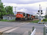 CN 308 hits the crossing next to the station at a good speed.