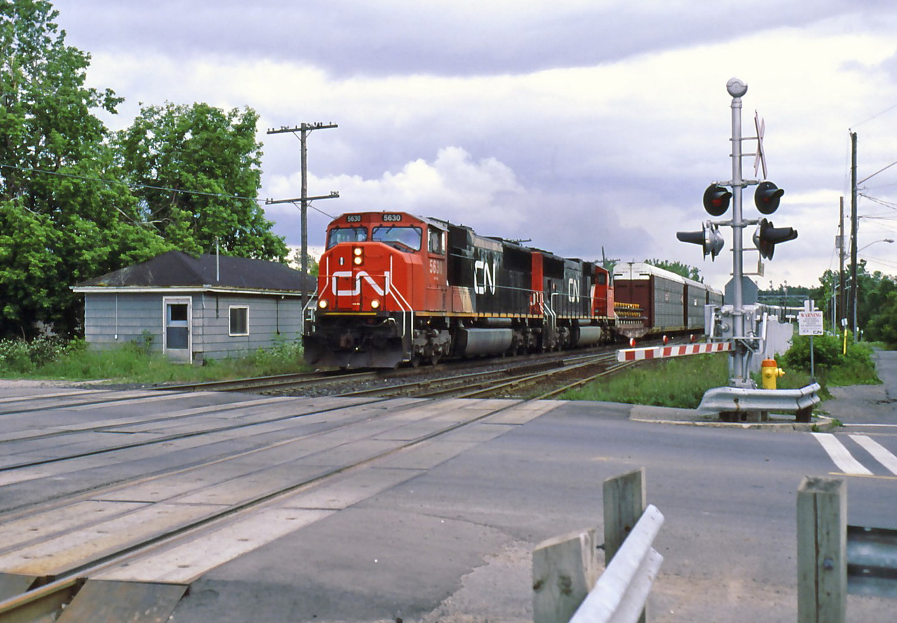 CN 308 hits the crossing next to the station at a good speed.