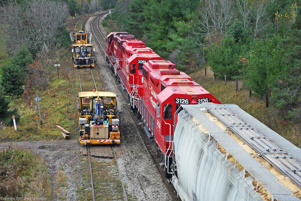 Delayed T07 races with engineering services on the siding in Pontypool Ontario.