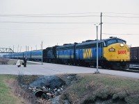 On a cold gray snowless late December afternoon Via #43/53 the morning Capitale/Lakeshore rolls into the Via Oshawa station with two GMD's and a high speed geared MLW RS-18 ( 6526, 66xx, 31xx). December 1979 Kodachrome by S. Danko.