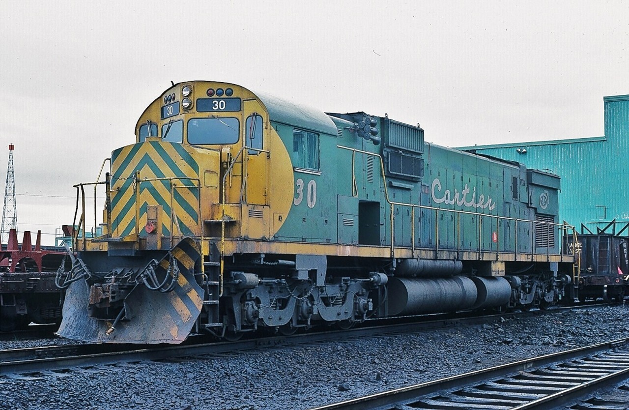 It is an ALCO!  And what a sight (and sound ) to behold – even in 1981 !  At a time when the major roads had divested ALCO power, the Quebec roads remained strong ALCO advocates – perhaps a tribute to the ALCO design pulling power. CART #30 is a C as in Century 630, former UP 2905. The unit was retired 1990. (what's interesting: some distance perspective, on an all Canadian route: Toronto is closer to Thunder Bay than to Port-Cartier; or drive Toronto to Quebec City, then drive that distance again on all two lane local highway – the two lane P.Q. Route #138 east into the Duplessis region is longer than Ontario's 401.). June 7, 1981 Port-Cartier, P.Q. Kodachrome by S.Danko.