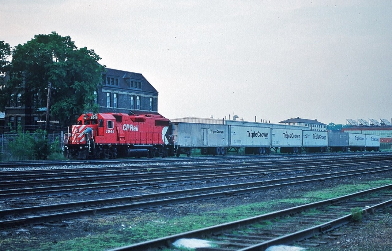 The recent CN Triple Crown images posted by Eric Portelli prompted me to dig out my CP Rail Triple Crown Kodachromes. So here is CP Rail GP 38-2 #3046 with the westbound (I believe this is westbound?) Triple Crown in London, Ontario - May 1991 ! [ Q: the building behind the unit:  is that the former CPR London Station?] Kodachrome by S. Danko.