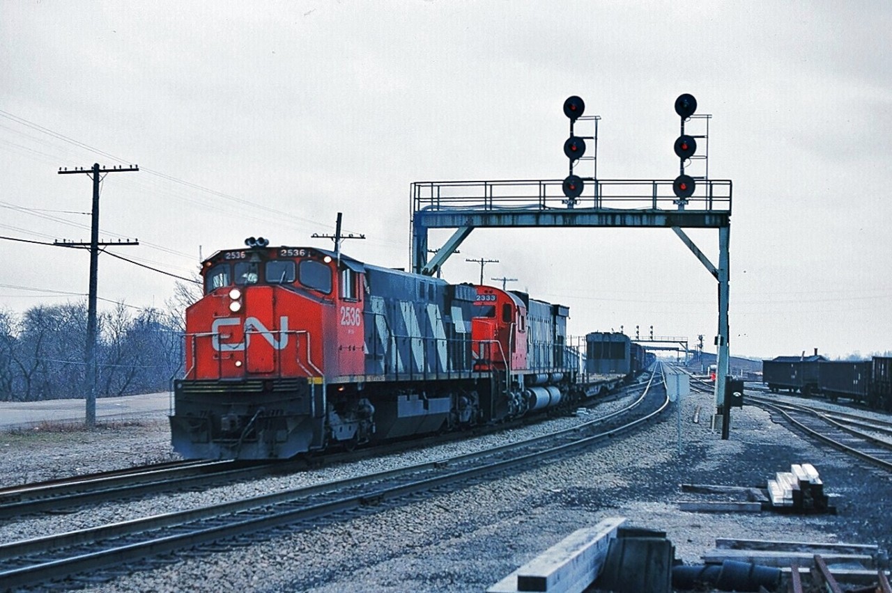 It is a dreary January 1980 afternoon as MLW M-420(W) #2536 and MLW M-636 #2333 team up on an eastbound extra at CN Paris Jct. My Trackside Guide shows the 2500's renumbered during 1986/7 into the 3500 series and divested between 1991 and 1998. The 2333 was retired by 1998.  Kodachrome by S. Danko.