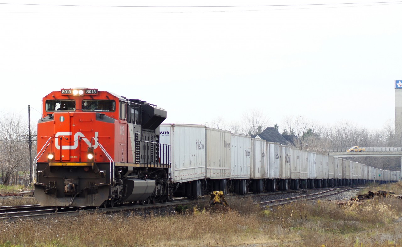 CN 144 with CN 8015 solo leads a long Triple Crown through Woodstock Ontario