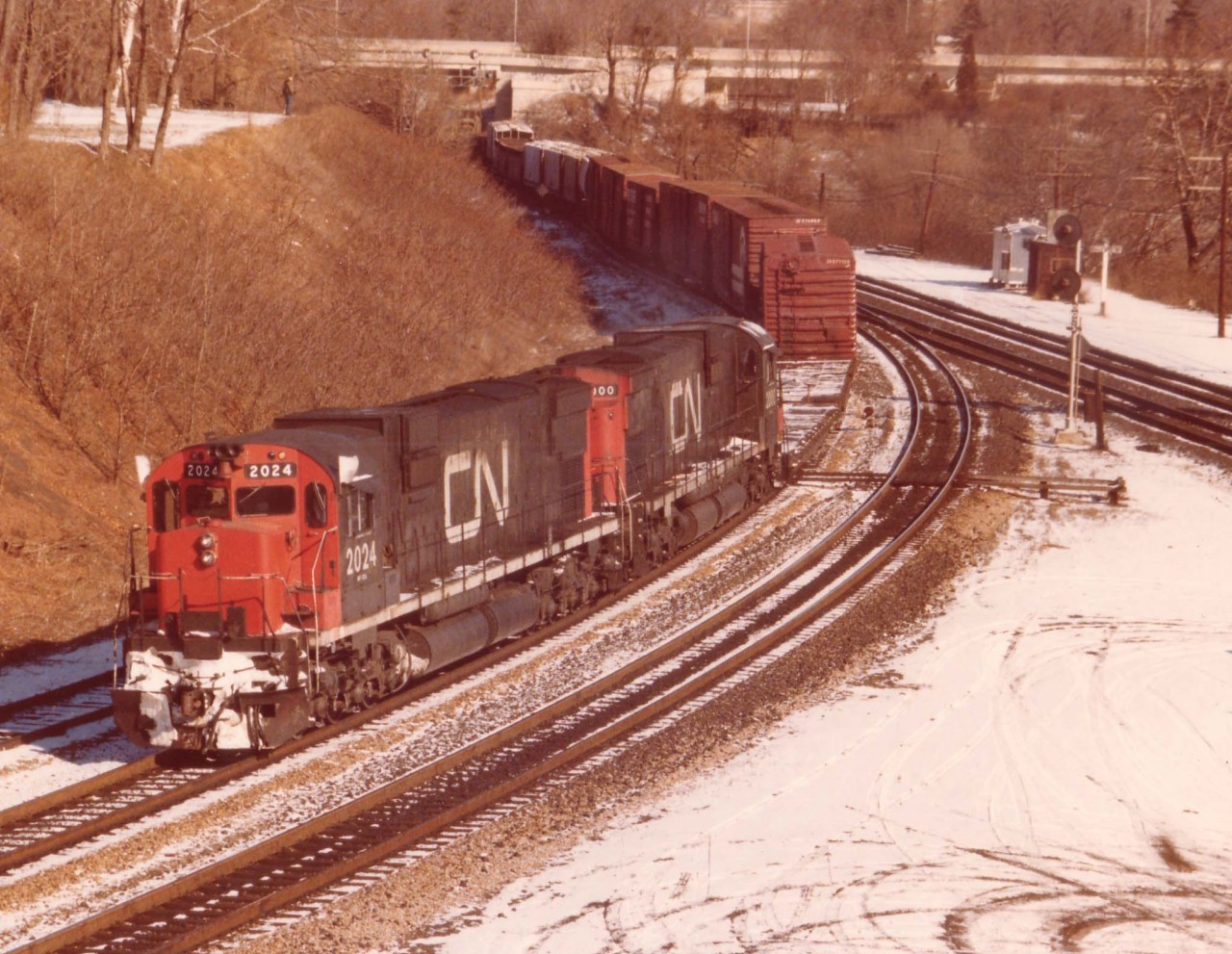 CN train #401 was a daily 'treat' for the fans. You never knew what kind of power would be on it. The railfan routine was to go into Hamilton's Stuart St yard and find out; for in the mornings this train would back out of Hamilton until clear of the Junction at Bayview and then get lined up westward up the Dundas Sub.
Today's CN 2024 and 2000, a pair of C-630Ms made for an eventful chase and I followed this train as far as Paris.
All locomotives in this series were off the CN roster by 1996.