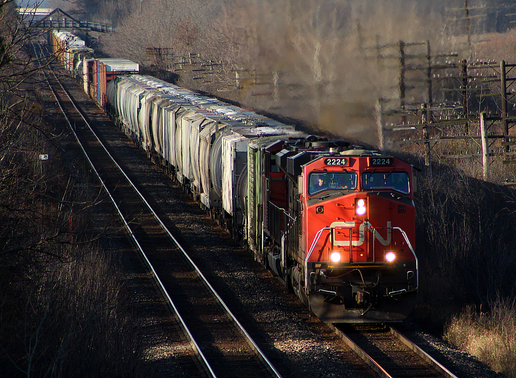 CN 332 powers towards London on a beautiful fall morning. In the background is the wooden bridge for Franks Lane.