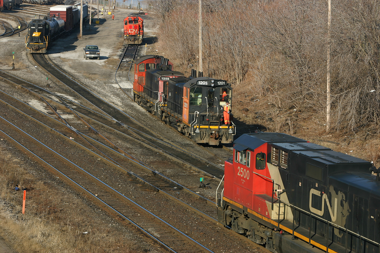 Back when Stuart Street Yard was a busy place, CN 422 arrives to set off some cars as RLK 4200 switches the lead and the crews arrive to take RLK 1201 and CN 4725 off the shop tracks.