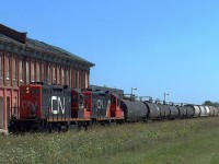 CN 584 heads west past the Canada Southern Station in St Thomas with CN 7059 leading August 28 2005