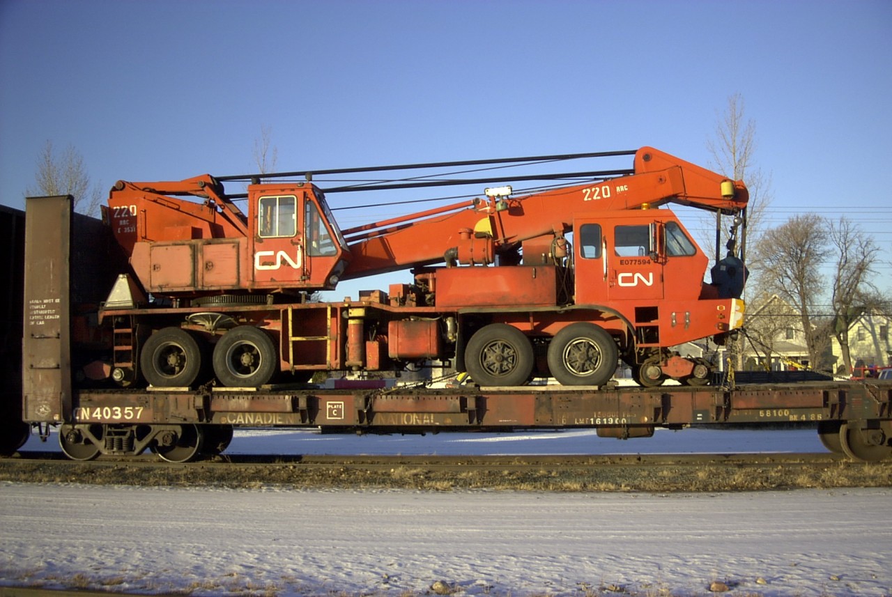 This CN bulkhead flat has been renumbered for Operations service (Engineering, Mechanical, Transportation) and now sits at the Work Equipment repair facility compound in Transcona with an Equipment Department Pettibone 220 RRC (110 ton capacity) wrecking crane on its deck. I believe the number sequence on the crane indicates it is 'E' equipment department, 'O' owned vehicle, '7' truck, '7' (77) year purchased, '594' sequential vehicle number.  This would make a great project for all the modelers out there.