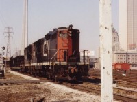 CN eastbound transfer with 4512 and 4520 skirts Union Station & the Royal York under the watchful eye of the new CN Tower.