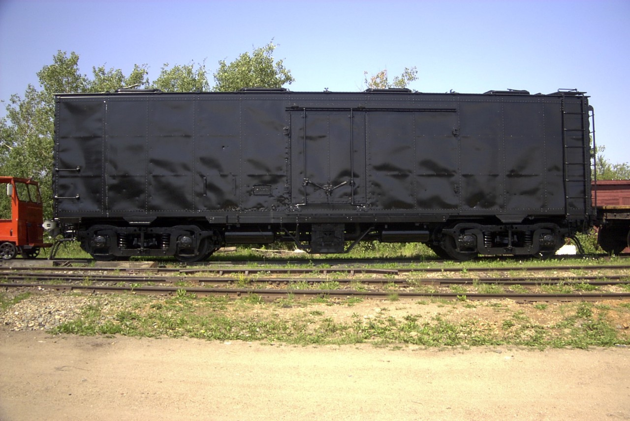 Back in Black! The smell of fresh paint was everywhere on this sunny hot day at the Alberta Railway Museum.  Ex-CN mechanical reefer (number unknown) was baking its new paint job as it sat in the yard surrounded by many other ex-CN pieces of equipment and power. This car was to eventually be painted in CN's 1950's olive green, black, and yellow stripe scheme.