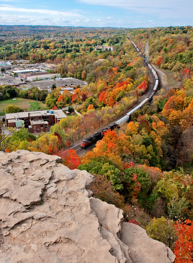 As we start into the middle of October mother nature is doing her worst on the colour as a few trees begin to lose there leaves, while others still cling on. The wail of dynamic brakes from a pair of CN units keep 7,317 ft of train in check on the downhill approach to Bayview at the bottom of the grade.