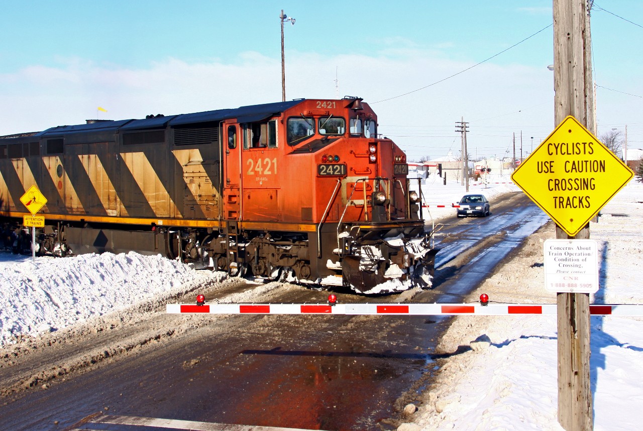Perspective: Here we see CN L509 pulling into the yard at London the day after the four-day "Snowmageddon" storm dumped almost 120cm of snow on the city. The sky has cleared, and most of the streets are cleared, giving me the unusual opportunity to shoot from on top of a snow pile that was taller than I am. So here I am almost 14 feet above street level, almost level with the nose of CN 2421; while I am not fond of the cold, a well-placed snow pile can yield a neat photo op!