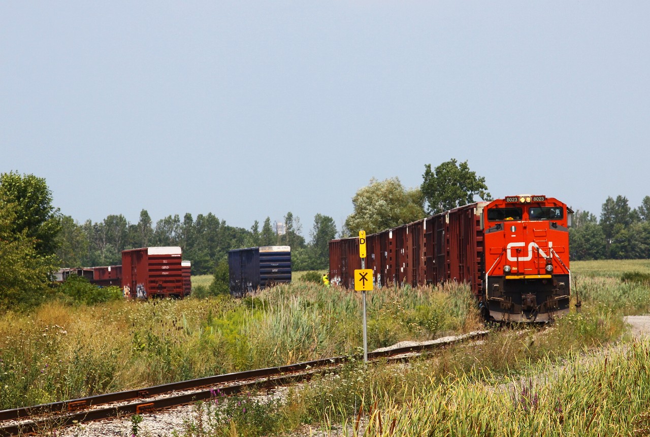 CN L562, CN 8023 South, cherrypicks a few loads out of the Abitibi paper plant interchange yard on what's left of the Thorold Spur. In addition to exchanging cars for the paper plant, the yard is used to store QTTX heavy duty flatcars along with a few other oddball pieces of equipment (an old CN slabside hopper is partially visible on the left side of the photo). After lifting five outbound loads, the crew made their way back to Port Robinson for lunch and ice cream.