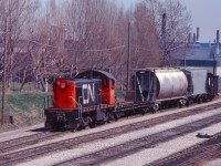 The West Industrial powered by CN 8172 drags a cut of cars out of the Hole
