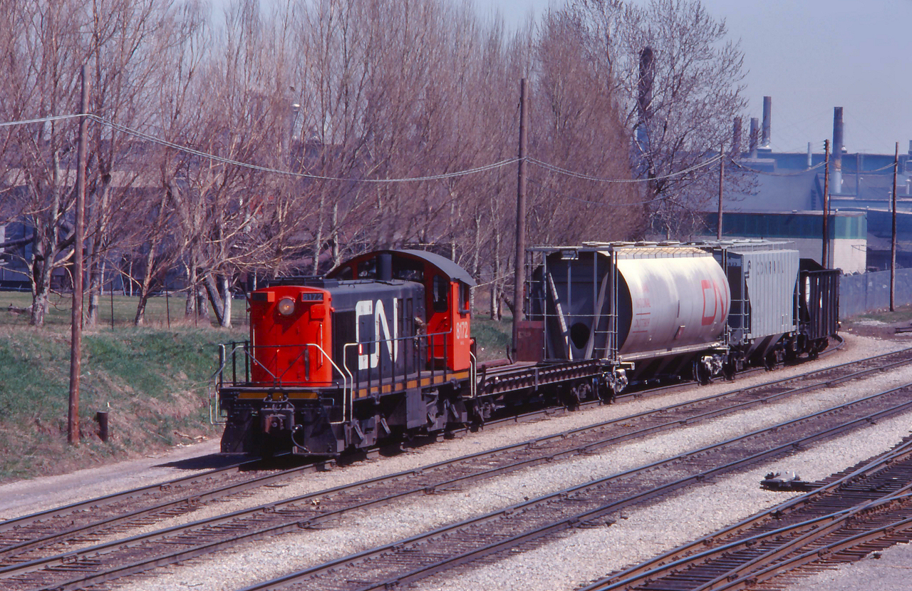 The West Industrial powered by CN 8172 drags a cut of cars out of the Hole