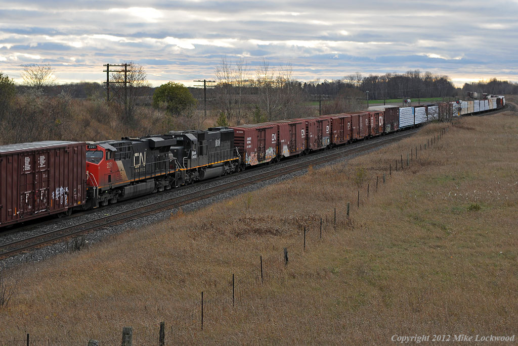CN train 369 has been getting DPU's recently, which has not been typical in these parts, so the sight of a 2 + 2 set up on it was a bit of a surprise. Typically 2 + 2 is more of a grain train set up, however maybe the 163 cars of this train warranted it. Power was CN 8811, 8814 up front and IC1038 and CN 2291 105 cars deep. 1641hrs.