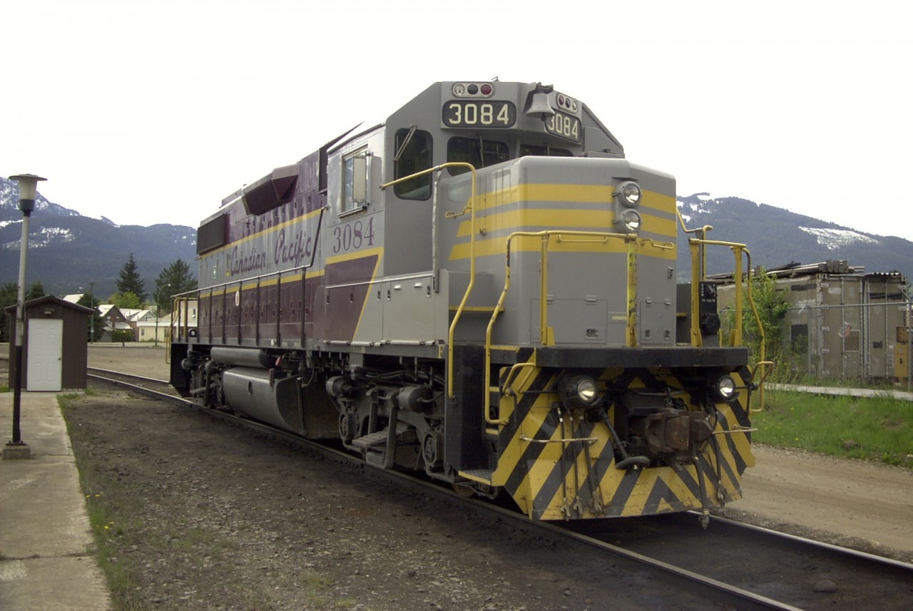 EMD GP38-2 CP 3084 rests in the afternoon sun outside the Revelstoke, BC car shop.  The unit was only in town for a day before it was hauled away to duty.  Even though it is mid-May, snow is still quite evident on the mountain slopes in the background.