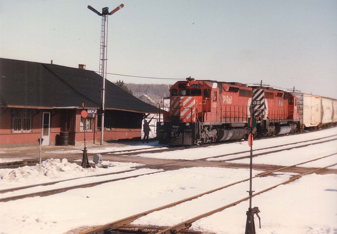Guelph Jct was not the same after the agent and the station disappeared in the later 1980s. In this view one can see the orders up by hoop as CP 5528, 5508 passes westbound on a nice cool March morning.That white on purple porcelain namesign is a treasure too.  I have often wondered where it ended up.