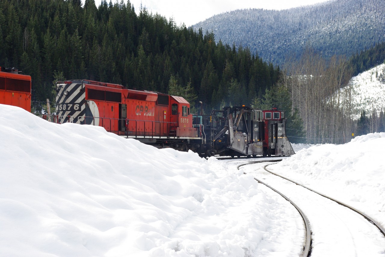 CP 5876 and a trailing 5900 series unit are moving a double ended plow train westbound through Rogers, BC.  There was a Russell wing snow plow and Jordan spreader on each end of the train for bi-direction snow clearing with plenty of power.