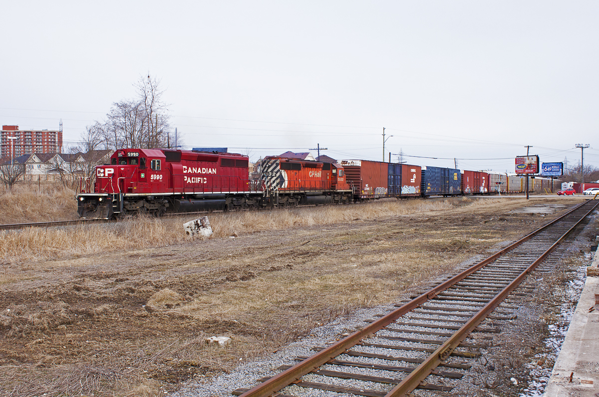 A scene that is no longer possible; I shot this from the loading dock of the old Purina factory in Whitby. The tracks in the foreground are gone, and the structure is in the process of being demolished.