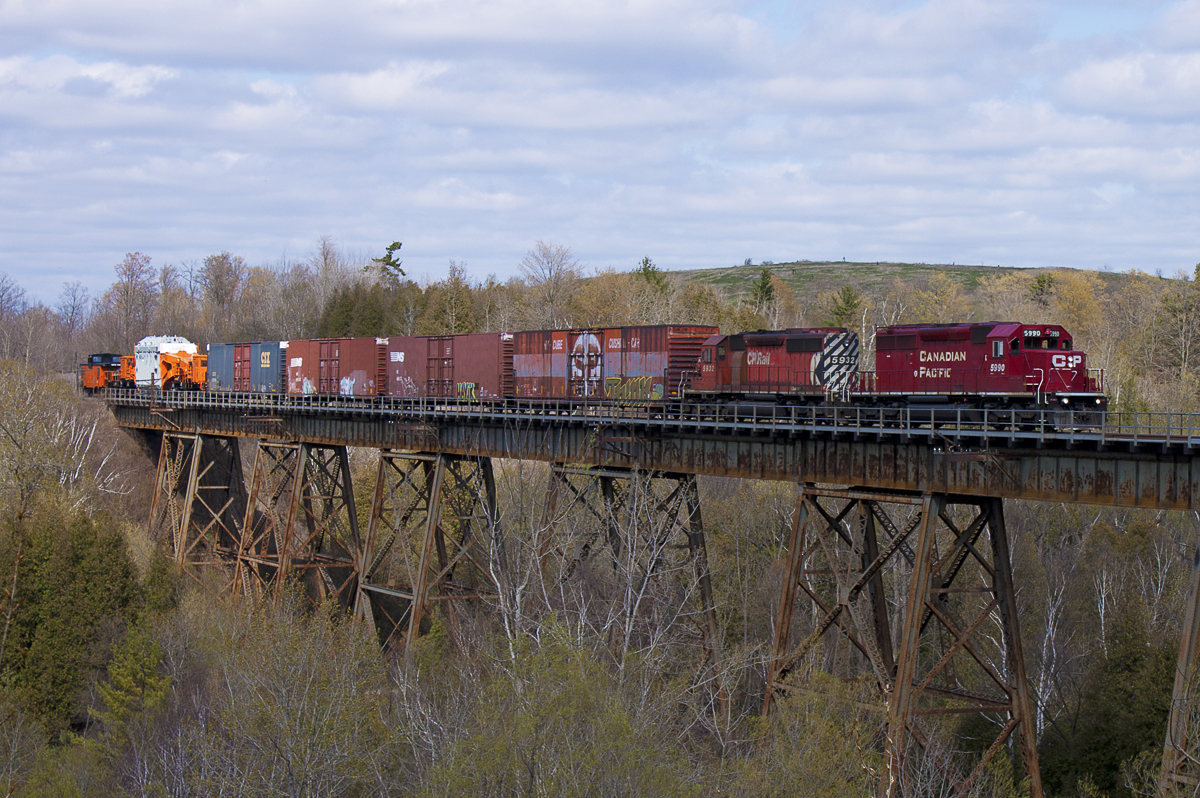 T18 passes over the Cherrywood trestle with a nice surprise at the end of the train. Hydro One's HEPX 200 and HEPX 79640 are destined for the Hydro One plant at the end of the Hornby Spur in Mississauga, ON.