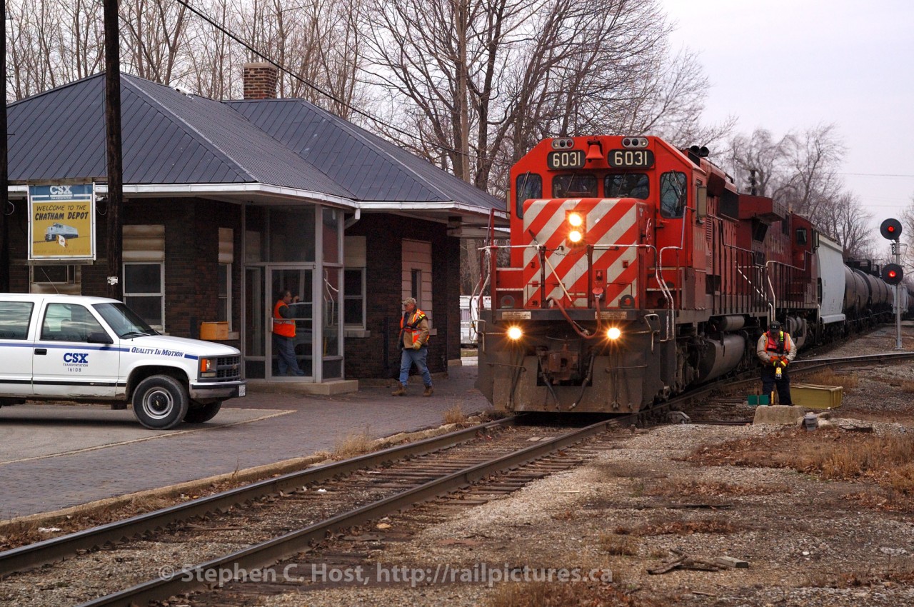 Train time in Chatham: D725 has arrived from Sarnia for the second last time - the Conductor and Brakemen have detrained - one to throw the switch to the CP Interchange, the other to grab paperwork inside the Chatham Depot. In the door to the station, Clerk "Skip" Dunn is greeting the crew upon arrival - Skip being the Clerk who handles paperwork, radios instructions to the crew (car locations, etc) and handles rover duty (using the truck at left). This was the second to last scheduled D725, the last freight operated the very next day (Sunday February 29 2006).