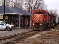 <b>Train time in Chatham:</b> D725 has arrived from Sarnia for the second last time - the Conductor and Brakemen have detrained - one to throw the switch to the CP Interchange, the other to grab paperwork inside the Chatham Depot. In the door to the station, Clerk "Skip" Dunn is greeting the crew upon arrival - Skip being the Clerk who handles paperwork, radios instructions to the crew (car locations, etc) and handles rover duty (using the truck at left). This was the second to last scheduled D725, the last freight operated the very next day (Sunday February 29 2006).
