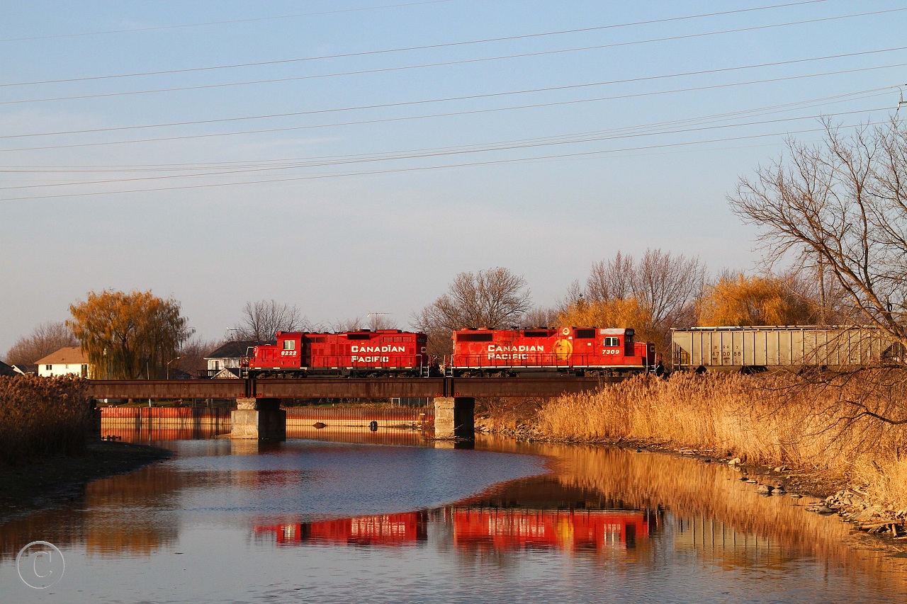 As they make their way westward back to Windsor, CP 8222 and CP 7309 with train T76 cross the Belle River in late afternoon light.